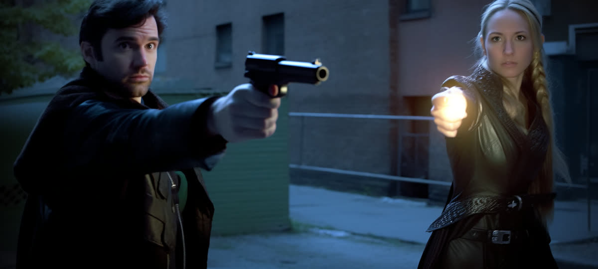A detective aims a pistol while his partner raises a glowing hand