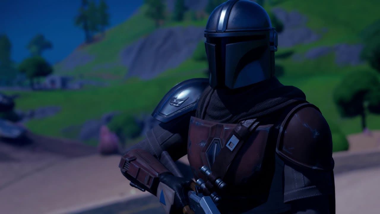 An armored bounty hunter on a grassy hill